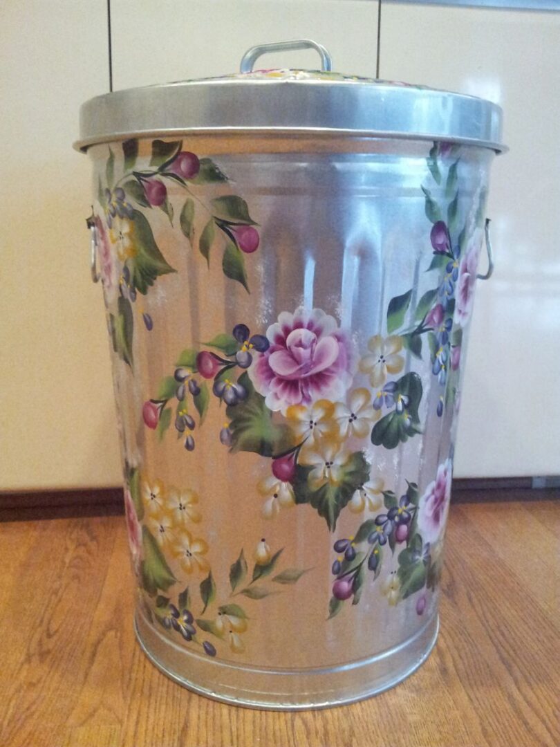 A stainless can with light purple and yellow flowers