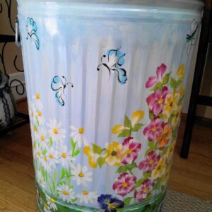 A can with light blue butterflies and pink, yellow, and white flowers