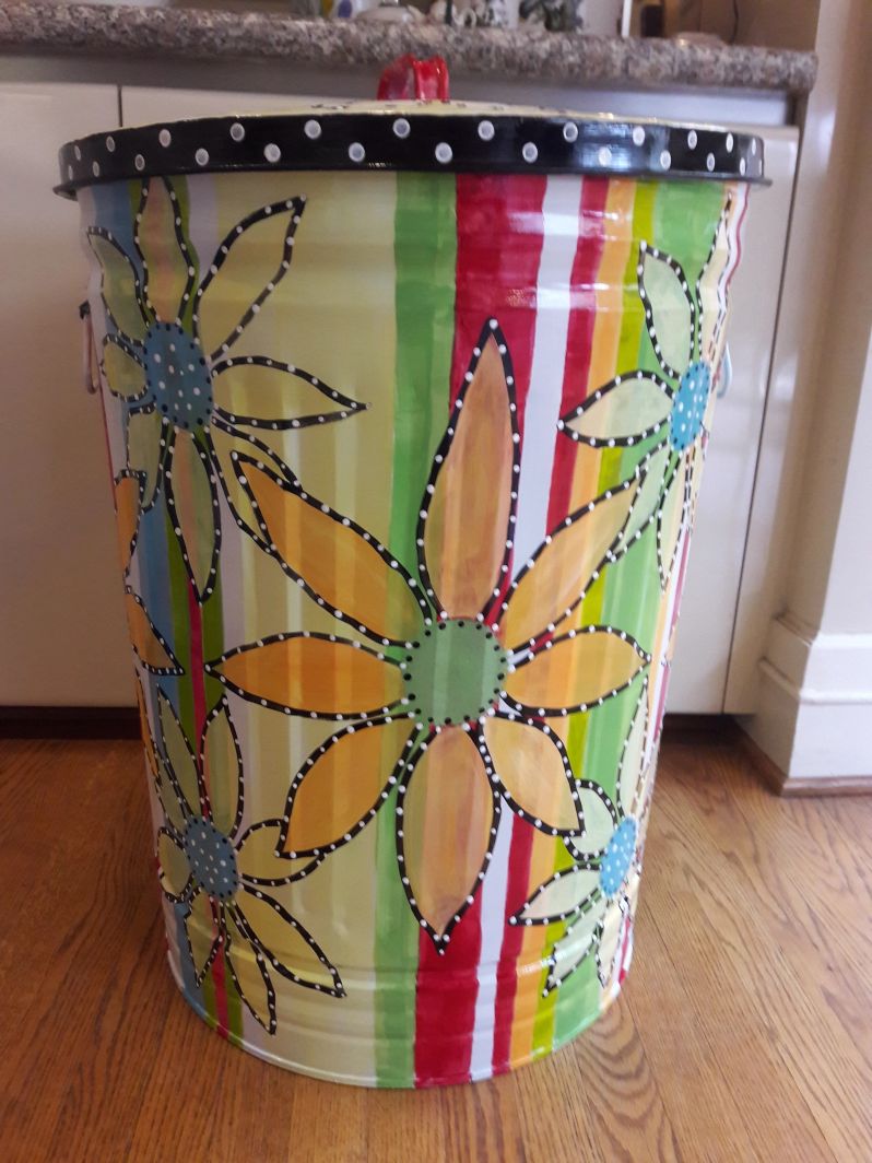 A rainbow-themed can with colorful huge flowers