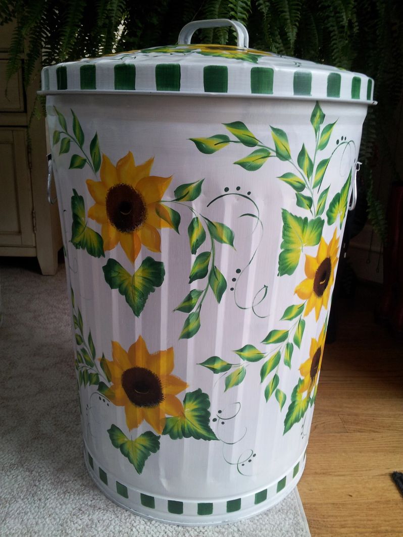 A can with white and green pattern and sunflower designs