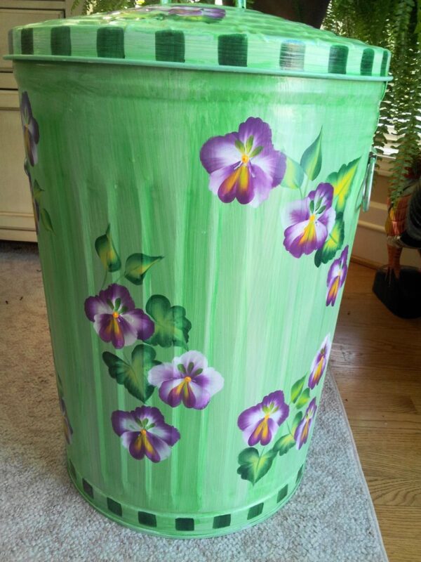 20 Gallon bright green wash, purple pansies, greenery, green checked trim. The Painted Can