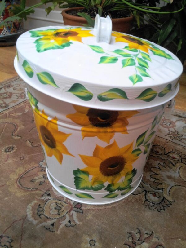 A small white can with huge sunflower designs