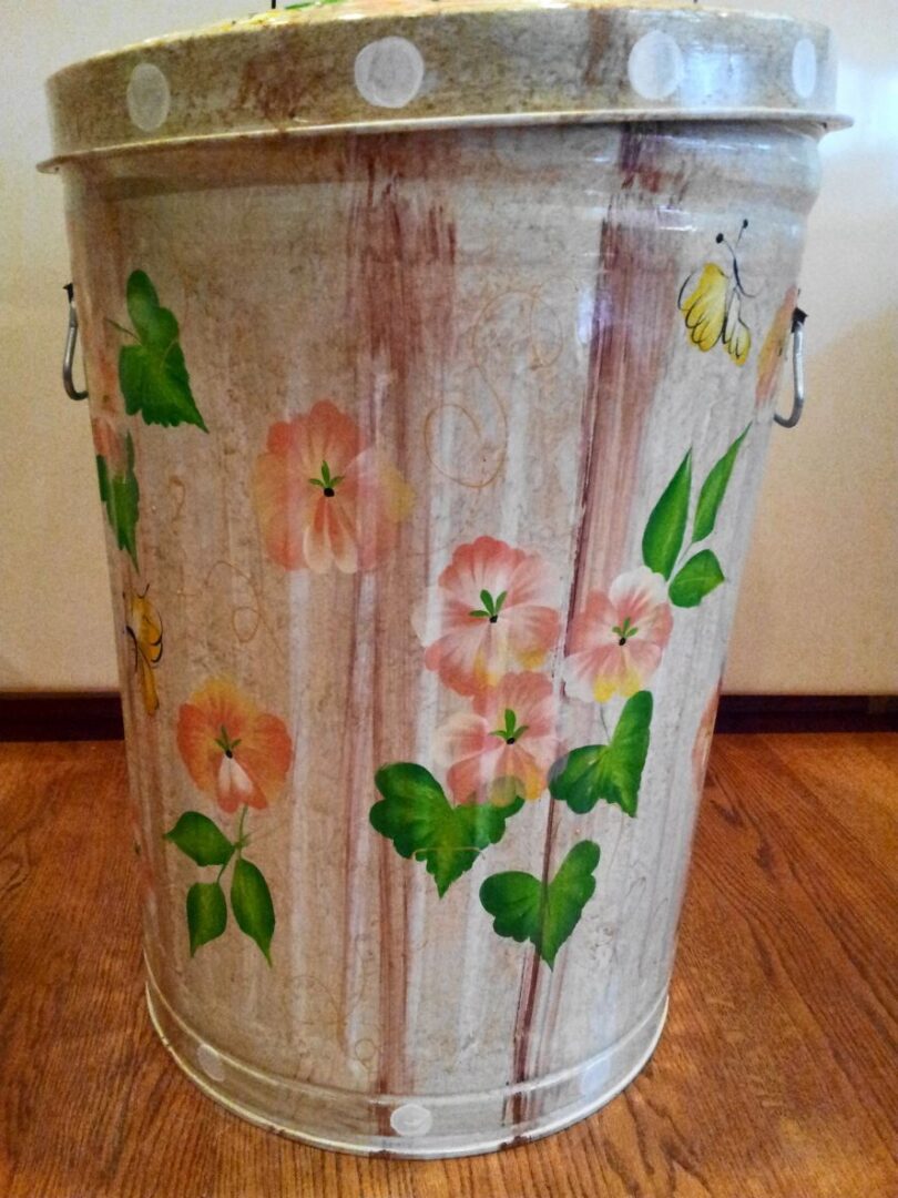 A light pink can with pink flowers and yellow butterflies
