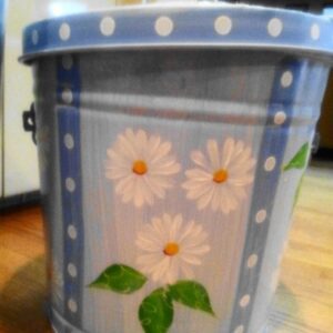 A light blue can with white polka dots and white flowers