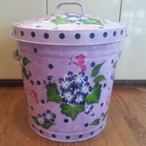 A lavender-colored can with black polka dots, blue flowers, and pink butterflies