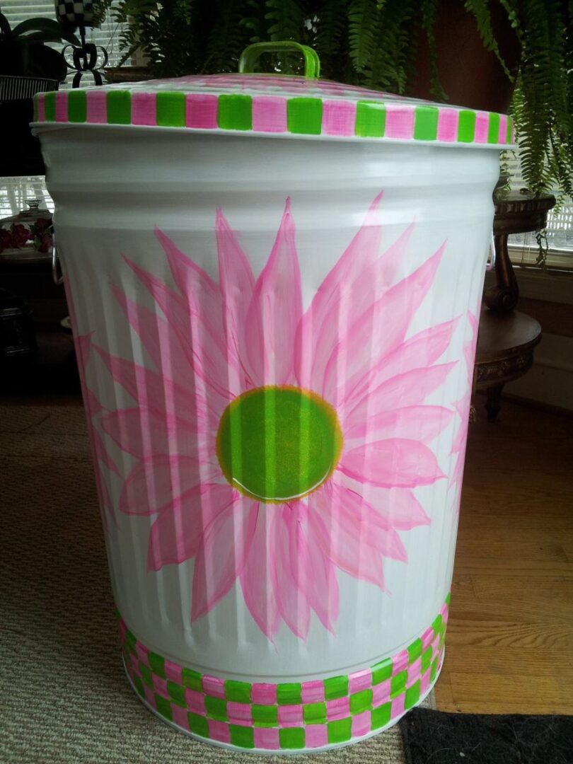 30 Gallon bright white with large pink daisies, pink and green checked trim. The Painted Can