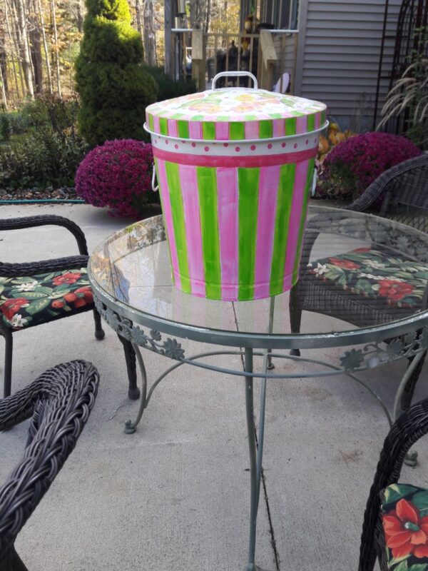 A can with pink and green stripes and small pink polka dots