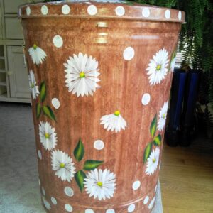 A brown can with white flowers and polka dots