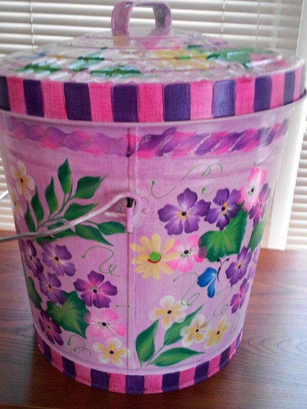 A pink can with purple details and colorful flowers