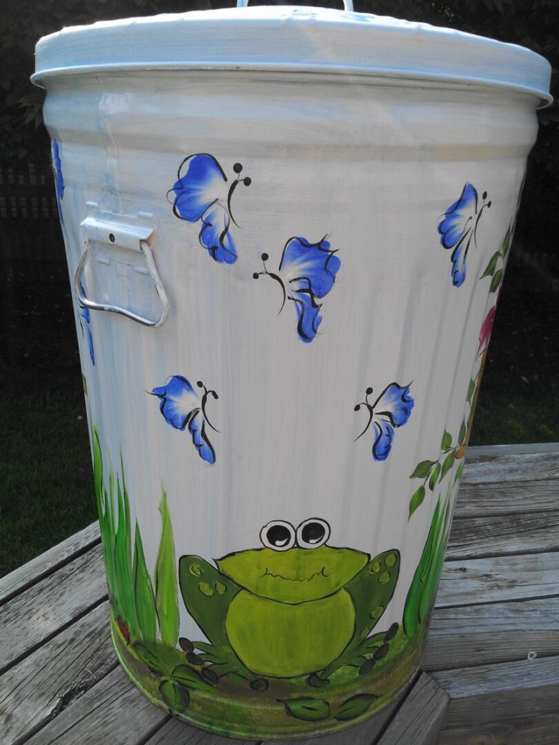 A white can with blue butterflies and a frog