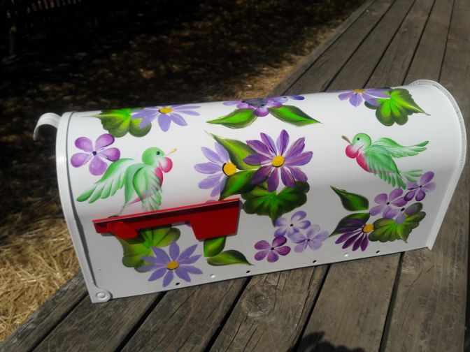 Mailbox bright white with purple floral, hummingbirds, greenery. The Painted Can